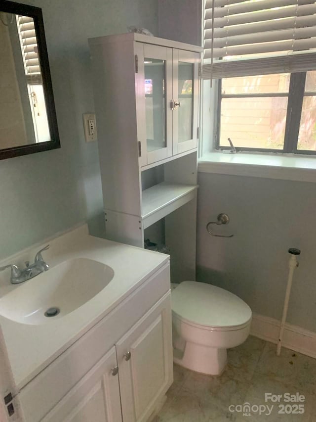 bathroom featuring toilet and vanity