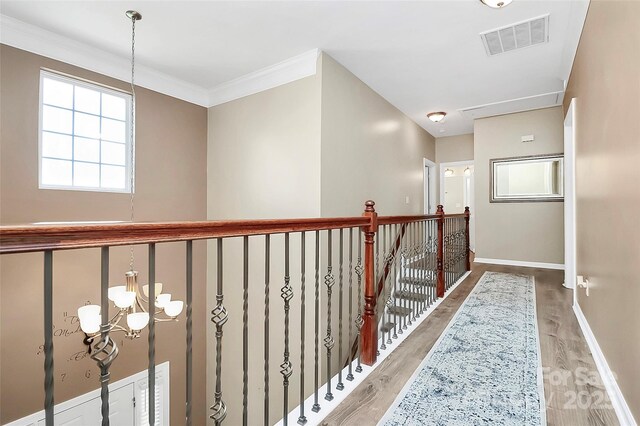 1618 Bay Meadows Ave NW, Concord, NC 28027 - hall featuring a chandelier, light wood-style floors, baseboards, and crown molding