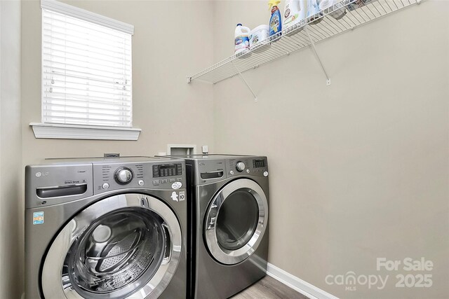 1618 Bay Meadows Ave NW, Concord, NC 28027 - washroom with washing machine and clothes dryer, baseboards, and wood finished floors