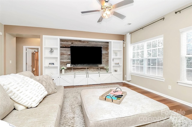 1618 Bay Meadows Ave NW, Concord, NC 28027 - living room featuring light wood finished floors, ceiling fan, baseboards, and built in features