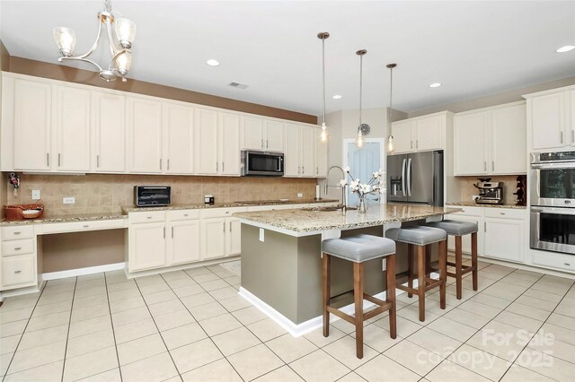 1618 Bay Meadows Ave NW, Concord, NC 28027 - kitchen featuring appliances with stainless steel finishes, backsplash, a chandelier, a sink, and recessed lighting