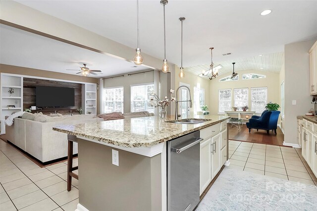 1618 Bay Meadows Ave NW, Concord, NC 28027 - kitchen featuring stainless steel dishwasher, open floor plan, a sink, light tile patterned flooring, and vaulted ceiling