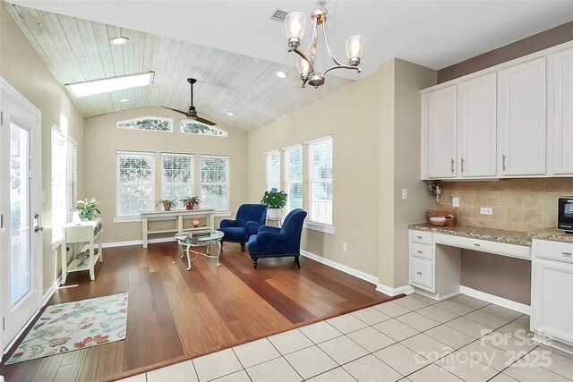 1618 Bay Meadows Ave NW, Concord, NC 28027 - living area with light wood-style flooring, vaulted ceiling, ceiling fan, baseboards, and a chandelier