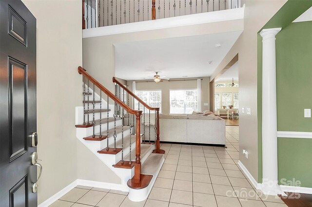 1618 Bay Meadows Ave NW, Concord, NC 28027 - foyer with ceiling fan, light tile patterned floors, stairs, and baseboards
