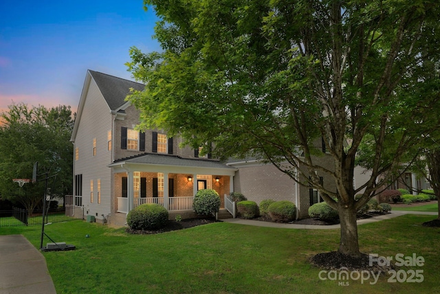 6718 Heritage Orchard Way, Huntersville, NC 28078 - view of front of house with covered porch, a lawn, and brick siding