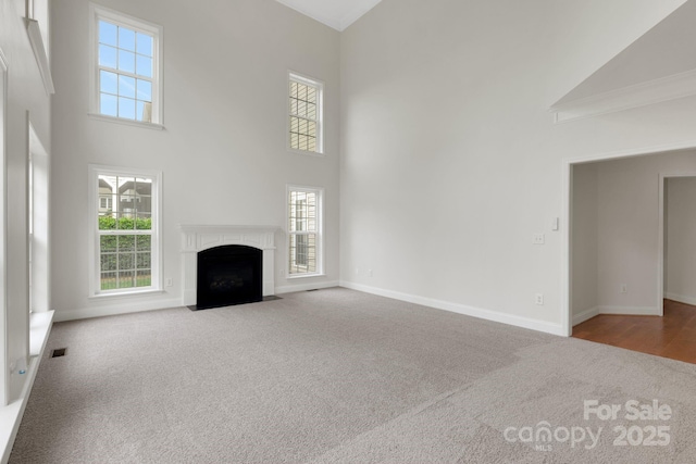 6718 Heritage Orchard Way, Huntersville, NC 28078 - unfurnished living room featuring carpet flooring, high vaulted ceiling, plenty of natural light, baseboards, and ornamental molding