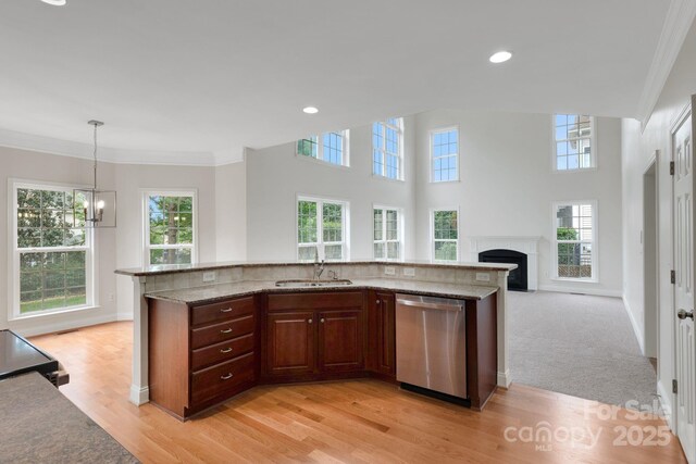6718 Heritage Orchard Way, Huntersville, NC 28078 - kitchen featuring stainless steel dishwasher, a sink, plenty of natural light, a fireplace, and ornamental molding