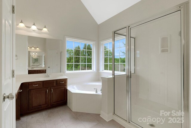 6718 Heritage Orchard Way, Huntersville, NC 28078 - bathroom with vaulted ceiling, vanity, a shower stall, a garden tub, and tile patterned floors