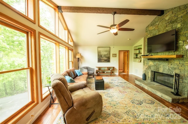 571 Ivy Ridge Cir, Sylva, NC 28779 - living area with healthy amount of natural light, wood finished floors, ceiling fan, beamed ceiling, and a fireplace