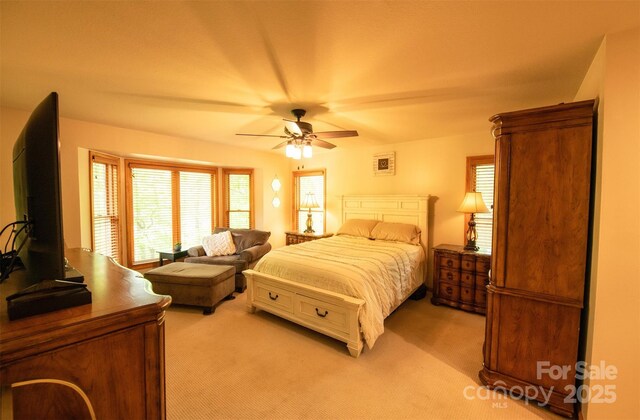 571 Ivy Ridge Cir, Sylva, NC 28779 - bedroom with light carpet, multiple windows, and ceiling fan