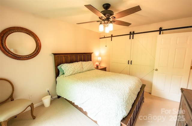 571 Ivy Ridge Cir, Sylva, NC 28779 - bedroom with light colored carpet, a barn door, ceiling fan, and baseboards