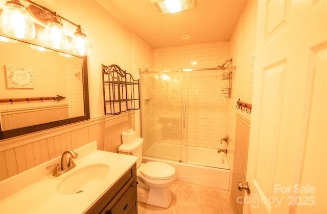 571 Ivy Ridge Cir, Sylva, NC 28779 - bathroom featuring a wainscoted wall, toilet, tile patterned floors, vanity, and enclosed tub / shower combo