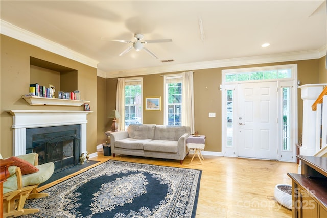 123 Singleton Rd, Mooresville, NC 28117 - living area with ornamental molding, a ceiling fan, light wood finished floors, a fireplace with flush hearth, and baseboards