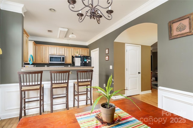123 Singleton Rd, Mooresville, NC 28117 - dining space featuring crown molding, light wood-style flooring, a chandelier, and arched walkways