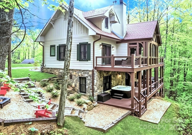 62 Blair Athel Pt, Waynesville, NC 28786 - rear view of house featuring stone siding, a deck, roof with shingles, a chimney, and a yard