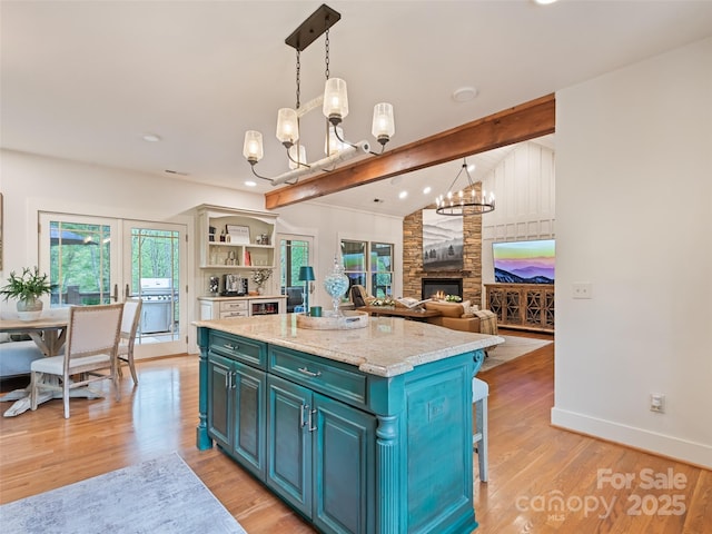 62 Blair Athel Pt, Waynesville, NC 28786 - kitchen featuring a chandelier, light wood-type flooring, a center island, baseboards, and open shelves