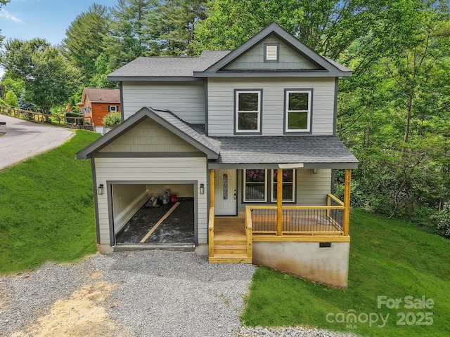 12 Whipoorwill Way, Waynesville, NC 28786 - view of front of property featuring a shingled roof, a porch, driveway, and a front yard