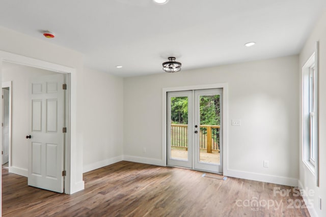 12 Whipoorwill Way, Waynesville, NC 28786 - empty room featuring french doors, wood finished floors, baseboards, and recessed lighting