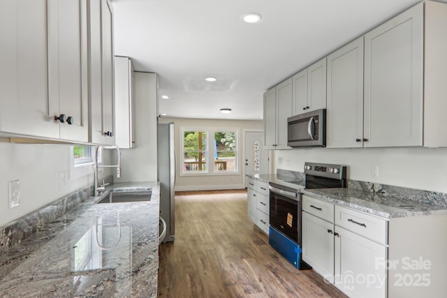 12 Whipoorwill Way, Waynesville, NC 28786 - kitchen with appliances with stainless steel finishes, a sink, wood finished floors, light stone countertops, and recessed lighting