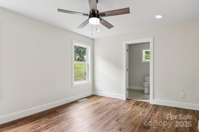 12 Whipoorwill Way, Waynesville, NC 28786 - unfurnished bedroom with baseboards, wood finished floors, connected bathroom, ceiling fan, and recessed lighting