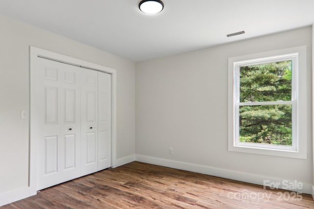12 Whipoorwill Way, Waynesville, NC 28786 - unfurnished bedroom featuring wood finished floors, baseboards, and a closet