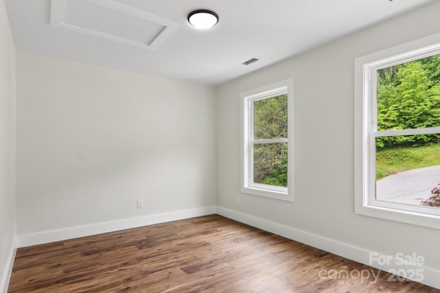 12 Whipoorwill Way, Waynesville, NC 28786 - empty room featuring attic access, wood finished floors, and baseboards