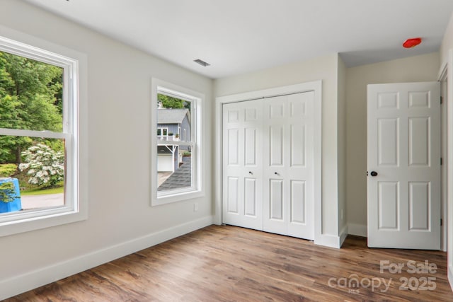 12 Whipoorwill Way, Waynesville, NC 28786 - unfurnished bedroom featuring baseboards, a closet, and wood finished floors