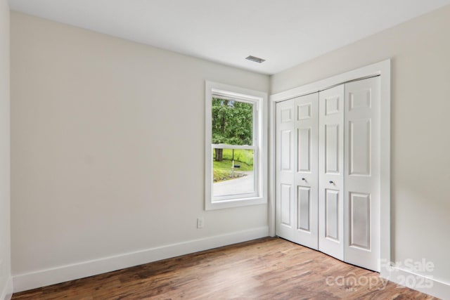 12 Whipoorwill Way, Waynesville, NC 28786 - unfurnished bedroom with baseboards, wood finished floors, and a closet
