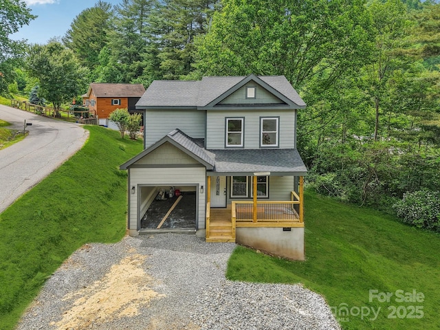 12 Whipoorwill Way, Waynesville, NC 28786 - view of front facade with a porch, gravel driveway, a shingled roof, a front lawn, and an attached garage