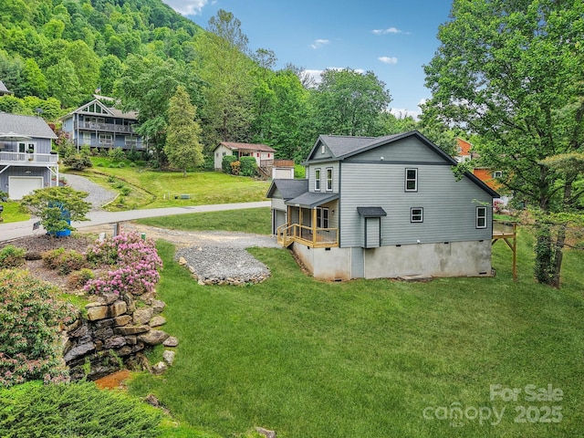 12 Whipoorwill Way, Waynesville, NC 28786 - view of side of property featuring a yard, driveway, and a forest view