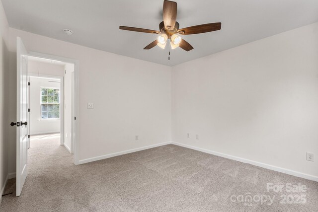 5529 Seths Dr, Charlotte, NC 28269 - carpeted empty room featuring a ceiling fan, baseboards, a smoke detector, and attic access