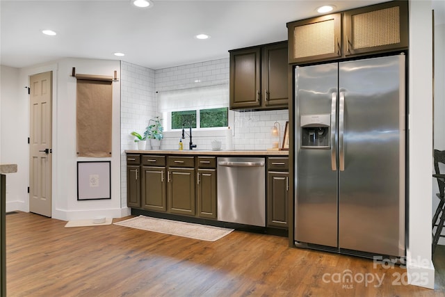 903 Middlefork Rd, Brevard, NC 28712 - kitchen with appliances with stainless steel finishes, wood finished floors, recessed lighting, tasteful backsplash, and light countertops