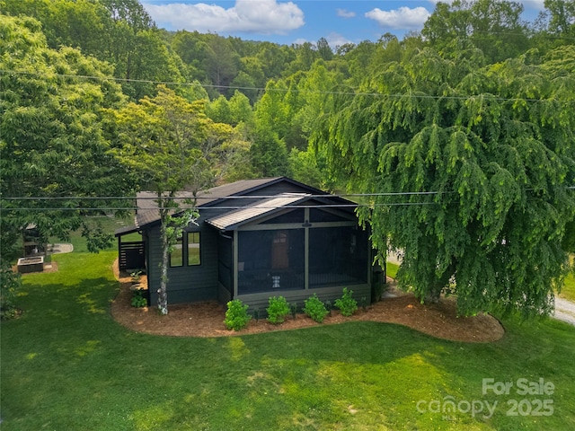 903 Middlefork Rd, Brevard, NC 28712 - rear view of property featuring a wooded view, a sunroom, a yard, and a metal roof