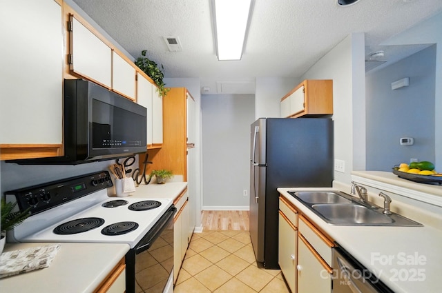 317 Cedarcroft Dr, Mooresville, NC 28115 - kitchen featuring appliances with stainless steel finishes, a sink, light countertops, light tile patterned flooring, and a textured ceiling