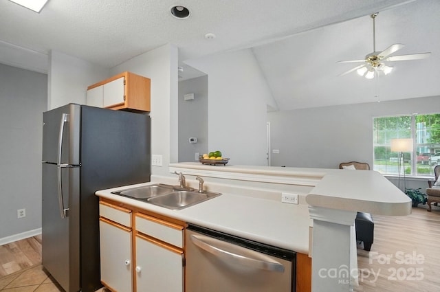 317 Cedarcroft Dr, Mooresville, NC 28115 - kitchen featuring appliances with stainless steel finishes, a sink, a ceiling fan, a peninsula, and light countertops