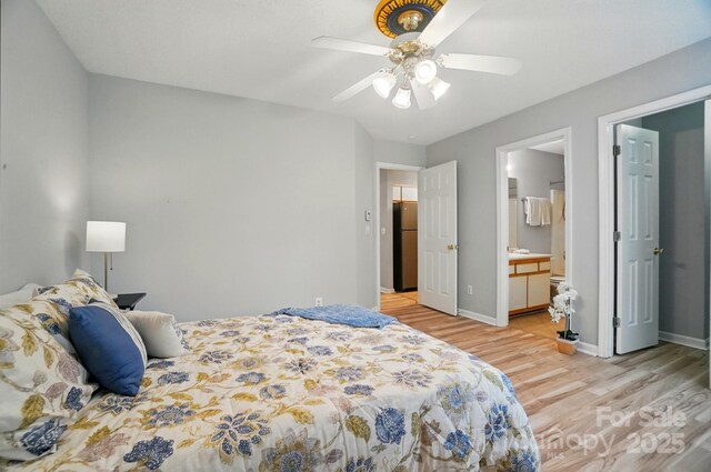 317 Cedarcroft Dr, Mooresville, NC 28115 - bedroom featuring freestanding refrigerator, light wood-style floors, baseboards, ceiling fan, and ensuite bath
