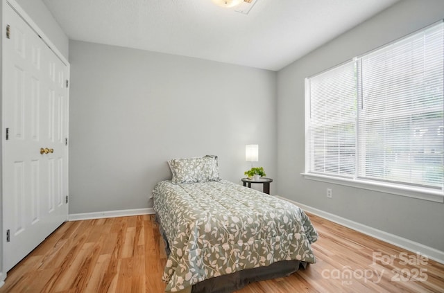 317 Cedarcroft Dr, Mooresville, NC 28115 - bedroom with multiple windows, baseboards, and light wood-type flooring
