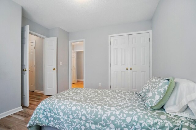 317 Cedarcroft Dr, Mooresville, NC 28115 - bedroom featuring wood finished floors, a closet, and baseboards
