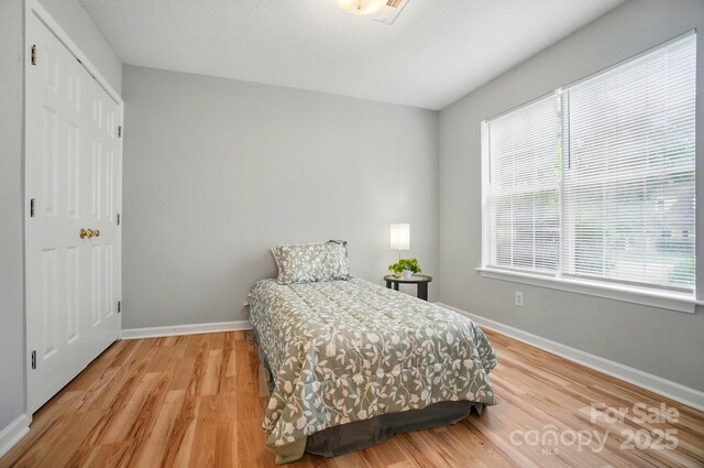 317 Cedarcroft Dr, Mooresville, NC 28115 - bedroom featuring light wood finished floors, baseboards, and a closet