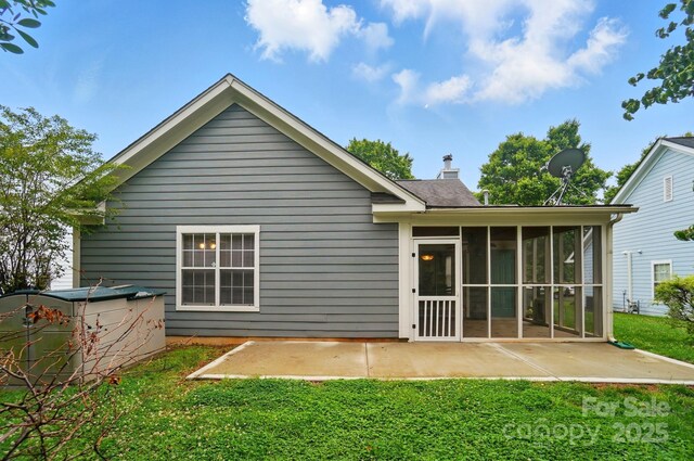 317 Cedarcroft Dr, Mooresville, NC 28115 - rear view of house with a patio area, a sunroom, a yard, and a chimney