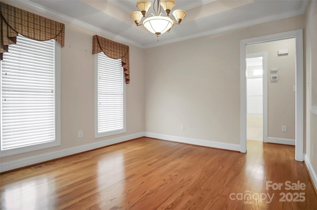 814 Settlers Dr, Cherryville, NC 28021 - spare room with light wood-style floors, a chandelier, crown molding, plenty of natural light, and a tray ceiling