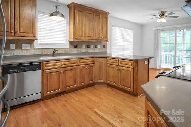 814 Settlers Dr, Cherryville, NC 28021 - kitchen featuring stainless steel dishwasher, a sink, ceiling fan, a peninsula, and brown cabinetry