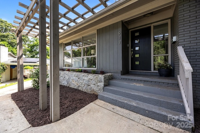 917 Dent Ct, Charlotte, NC 28210 - view of exterior entry featuring brick siding and a pergola