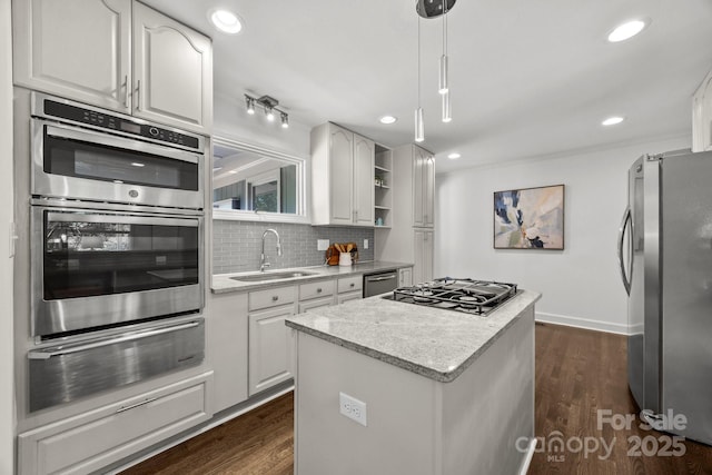 917 Dent Ct, Charlotte, NC 28210 - kitchen with appliances with stainless steel finishes, a warming drawer, a center island, tasteful backsplash, and white cabinets