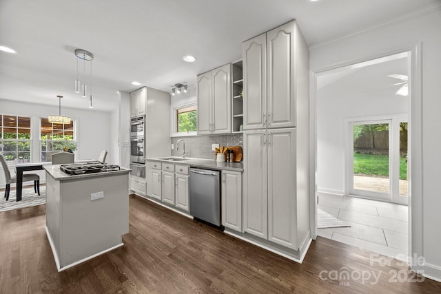 917 Dent Ct, Charlotte, NC 28210 - kitchen with stainless steel appliances, a center island, decorative backsplash, hanging light fixtures, and ceiling fan