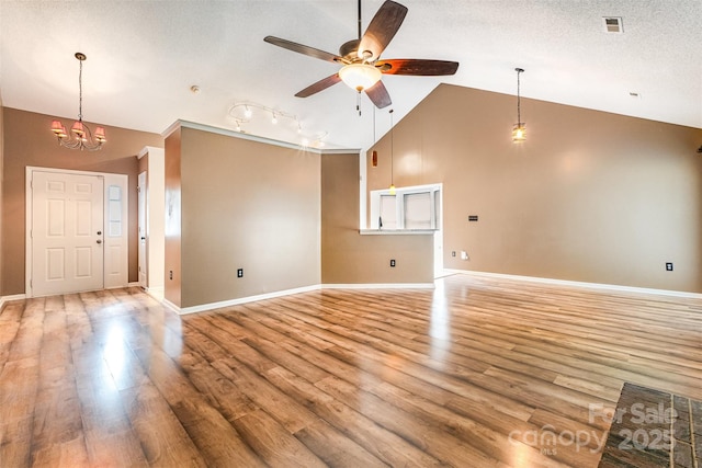 3505 Frostmoor Pl, Charlotte, NC 28269 - unfurnished living room featuring a ceiling fan, light wood finished floors, baseboards, a chandelier, and high vaulted ceiling