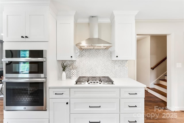 3661 Annlin Ave, Charlotte, NC 28209 - kitchen featuring wall chimney exhaust hood, double oven, gas stovetop, light countertops, and wood finished floors
