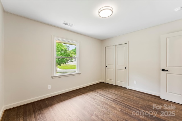 3661 Annlin Ave, Charlotte, NC 28209 - unfurnished bedroom featuring wood finished floors, baseboards, and a closet