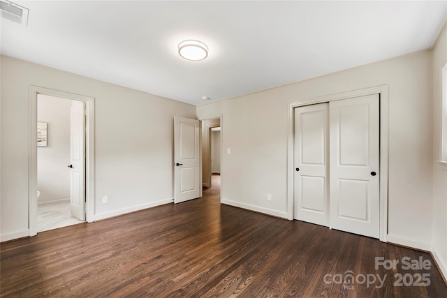 3661 Annlin Ave, Charlotte, NC 28209 - unfurnished bedroom featuring dark wood-style flooring, a closet, baseboards, and ensuite bath
