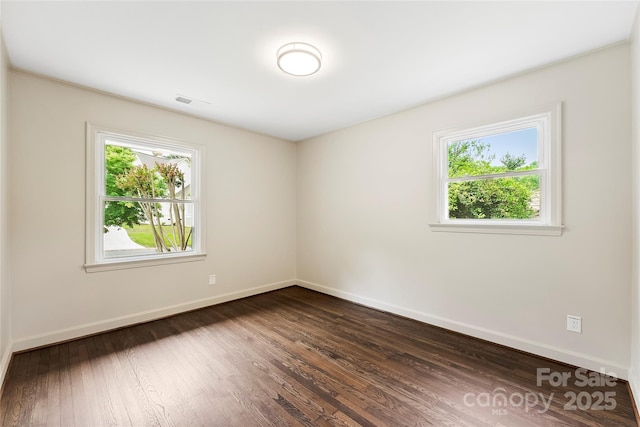 3661 Annlin Ave, Charlotte, NC 28209 - spare room featuring healthy amount of natural light, baseboards, and dark wood-style flooring